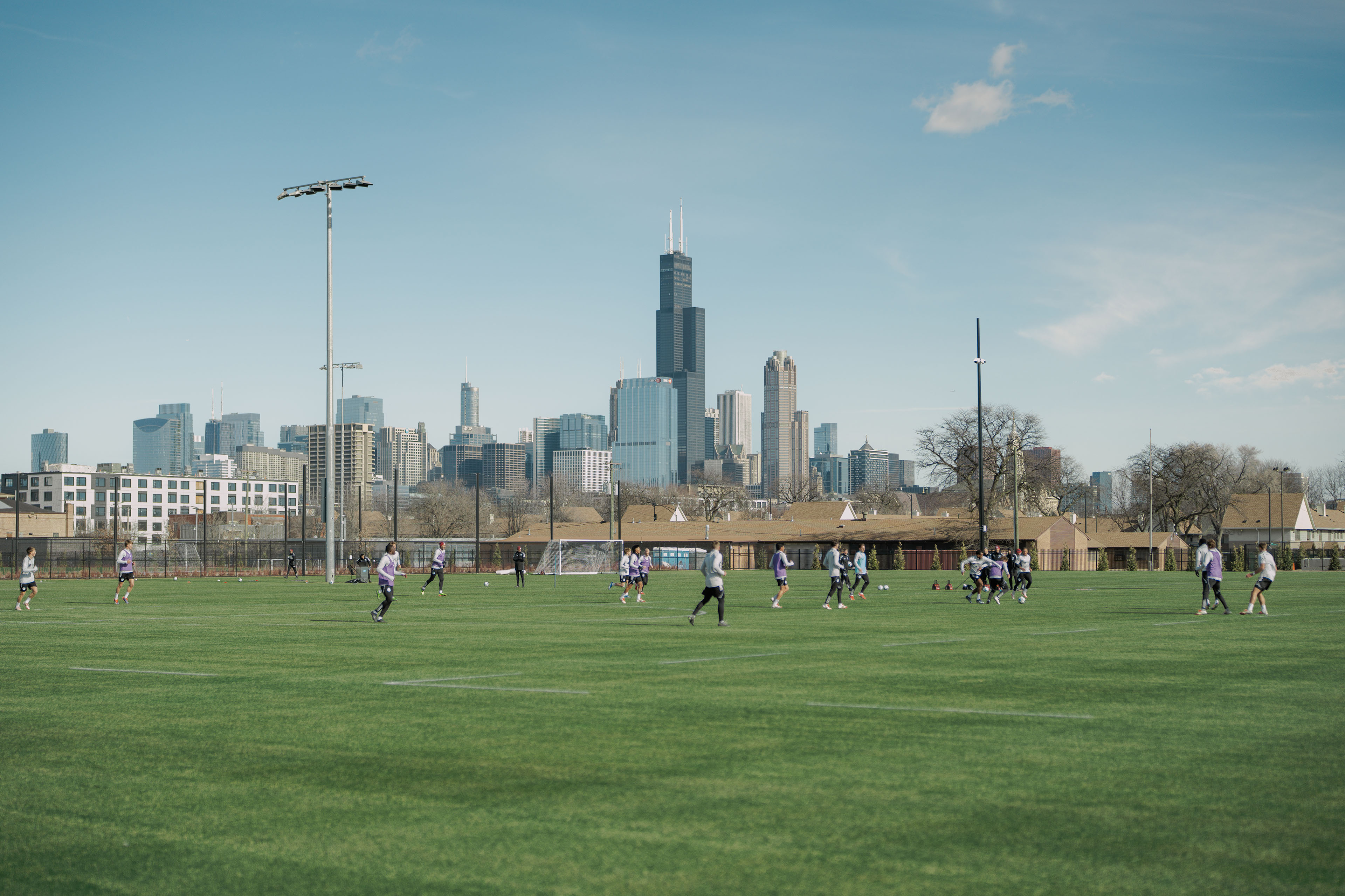 Shot of Chicago Fire team training at the new performance center with the Chicago skyline in the background