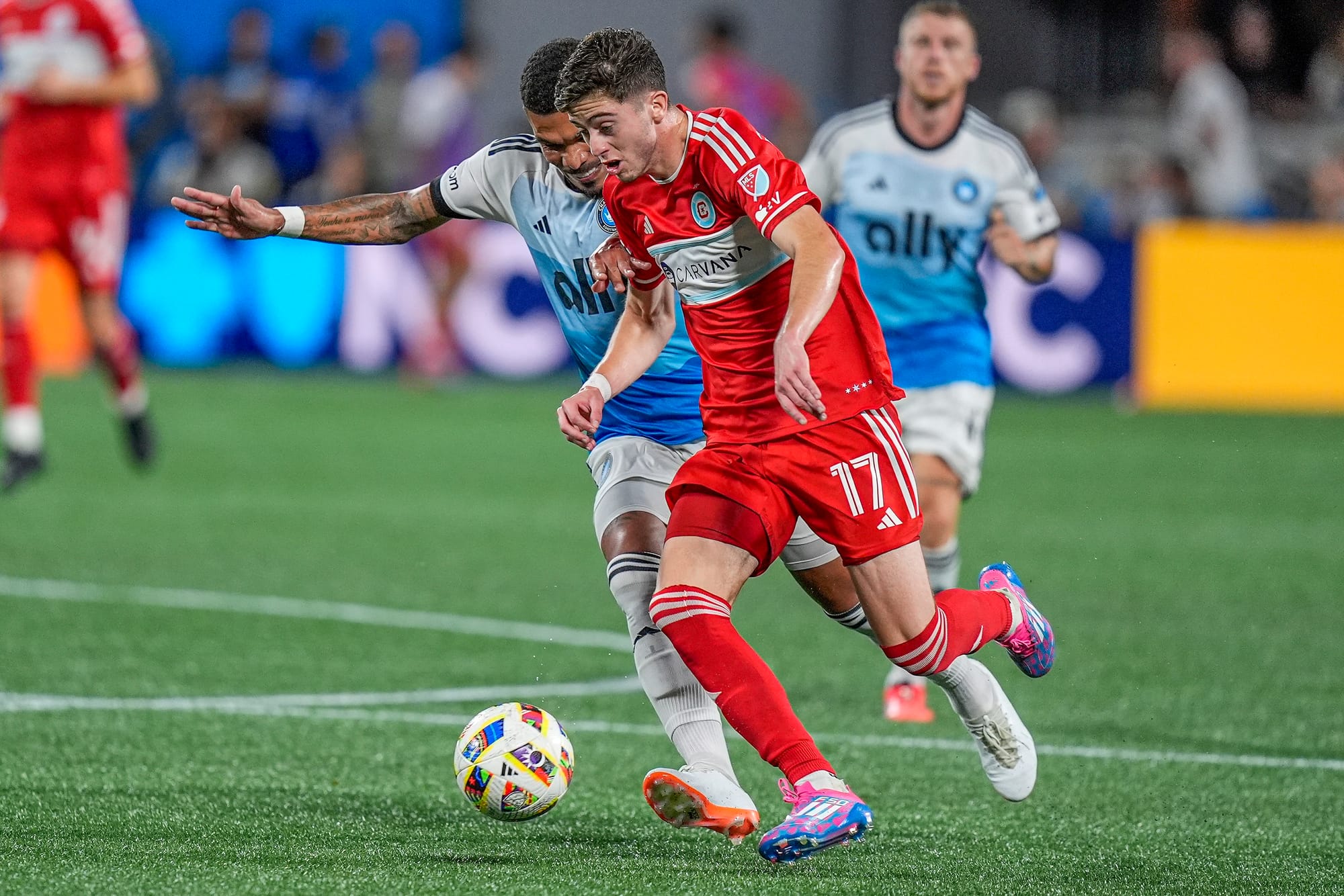 Oct 2, 2024; Charlotte, North Carolina, USA; Chicago Fire FC midfielder Brian Gutierrez (17) dribbles the ball pressured by Charlotte FC midfielder Junior Urso (30) during the second half at Bank of America Stadium. (Jim Dedmon-Imagn Images)