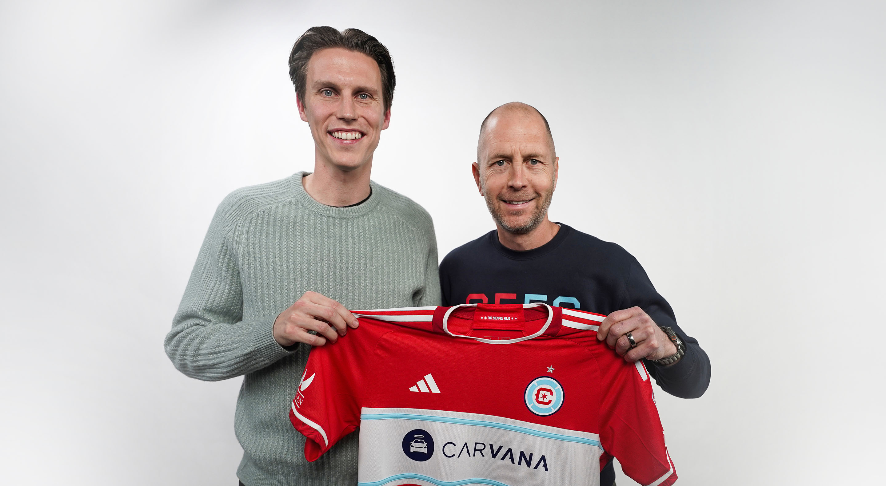 Portrait of Jack Elliott with Gregg Berhalter, holding up a Chicago Fire jersey