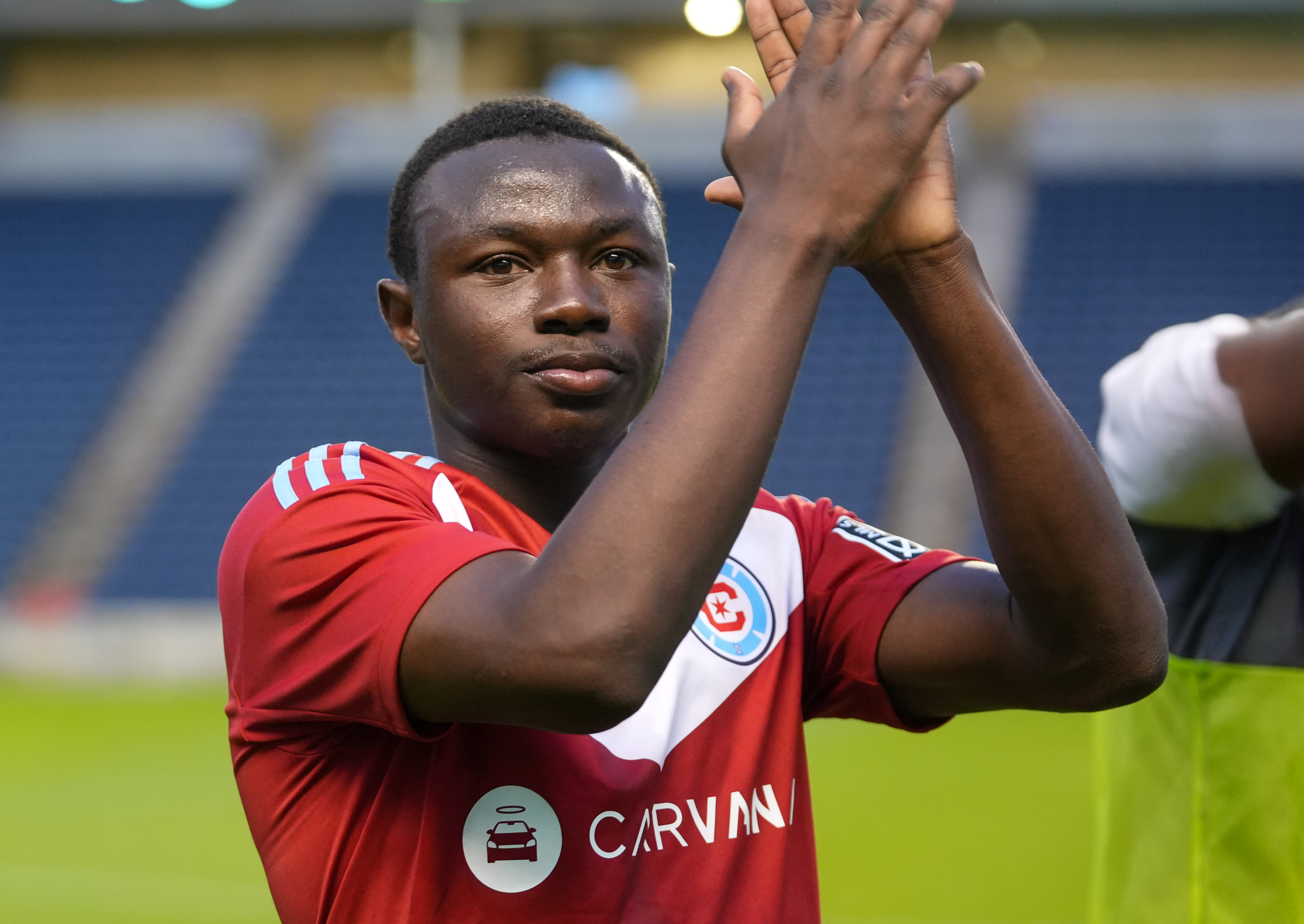 Close up shot of Omari Glasgow clapping in a Fire II uniform 