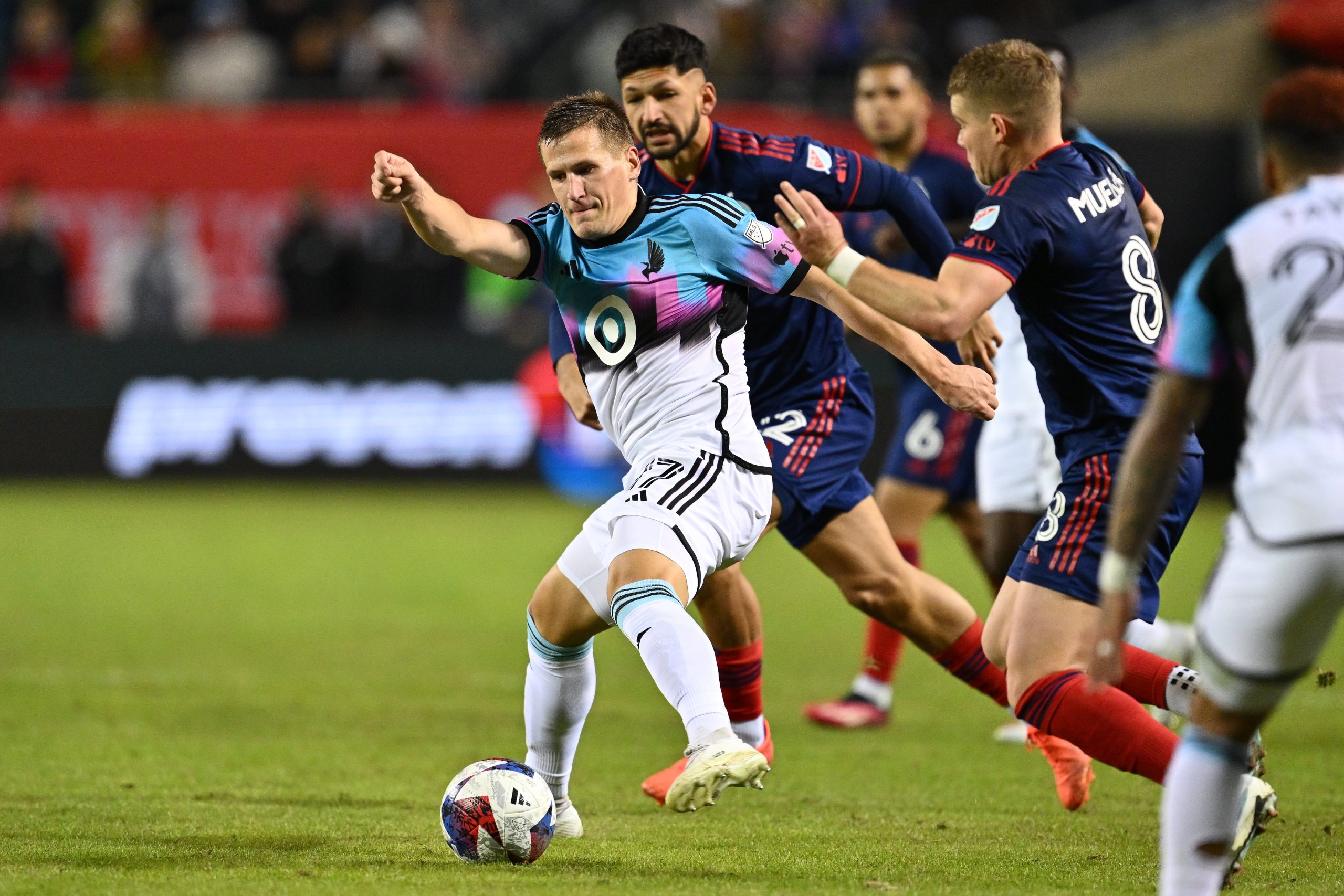 Apr 8, 2023; Chicago, Illinois, USA; Minnesota United midfielder Robin Lod (17) controls the ball as Chicago Fire FC defender Mauricio Pineda (22) and forward Chris Mueller (8) defend in the second half at Soldier Field. Mandatory Credit: Jamie Sabau-USA TODAY Sports