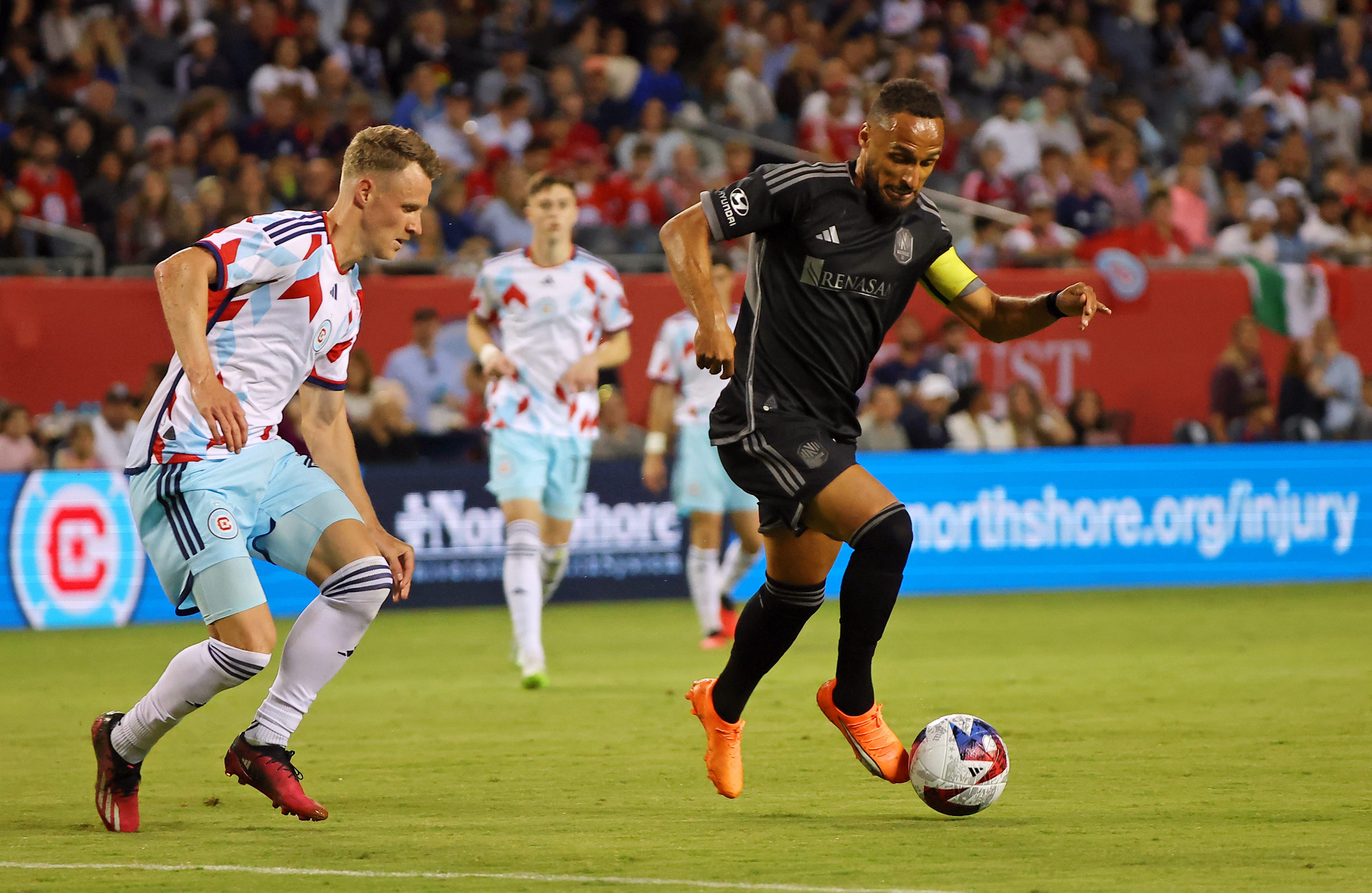 Jul 8, 2023; Chicago, Illinois, USA; Nashville SC midfielder Hany Mukhtar (10) dribbles the ball against Chicago Fire midfielder Fabian Herbers (21) during the second half at Soldier Field.