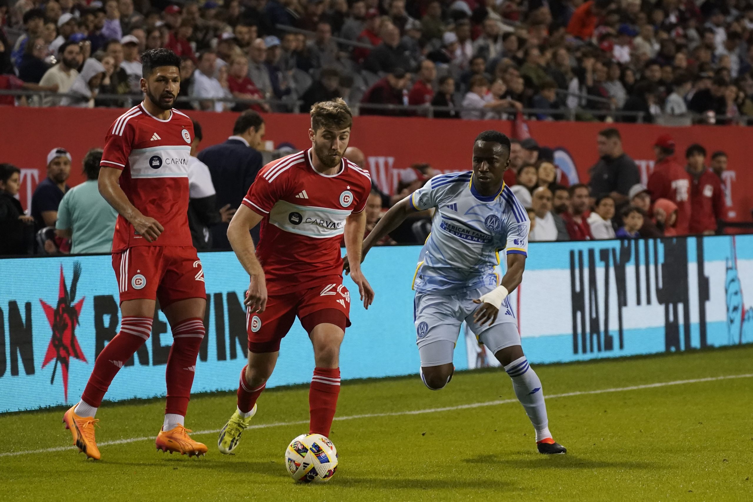 Apr 27, 2024; Chicago, Illinois, USA; Chicago Fire FC midfielder Jonathan Dean (24) controls the ball Atlanta United midfielder Edwin Mosquera (20) during the second half at Soldier Field. 