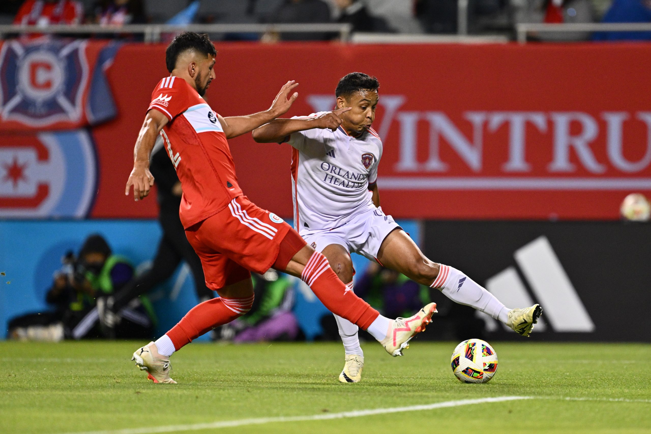 May 29, 2024; Chicago, Illinois, USA; Chicago Fire FC defender Mauricio Pineda (22) and Orlando City SC forward Luis Muriel (9) battle for control of the ball in the second half at Soldier Field. 