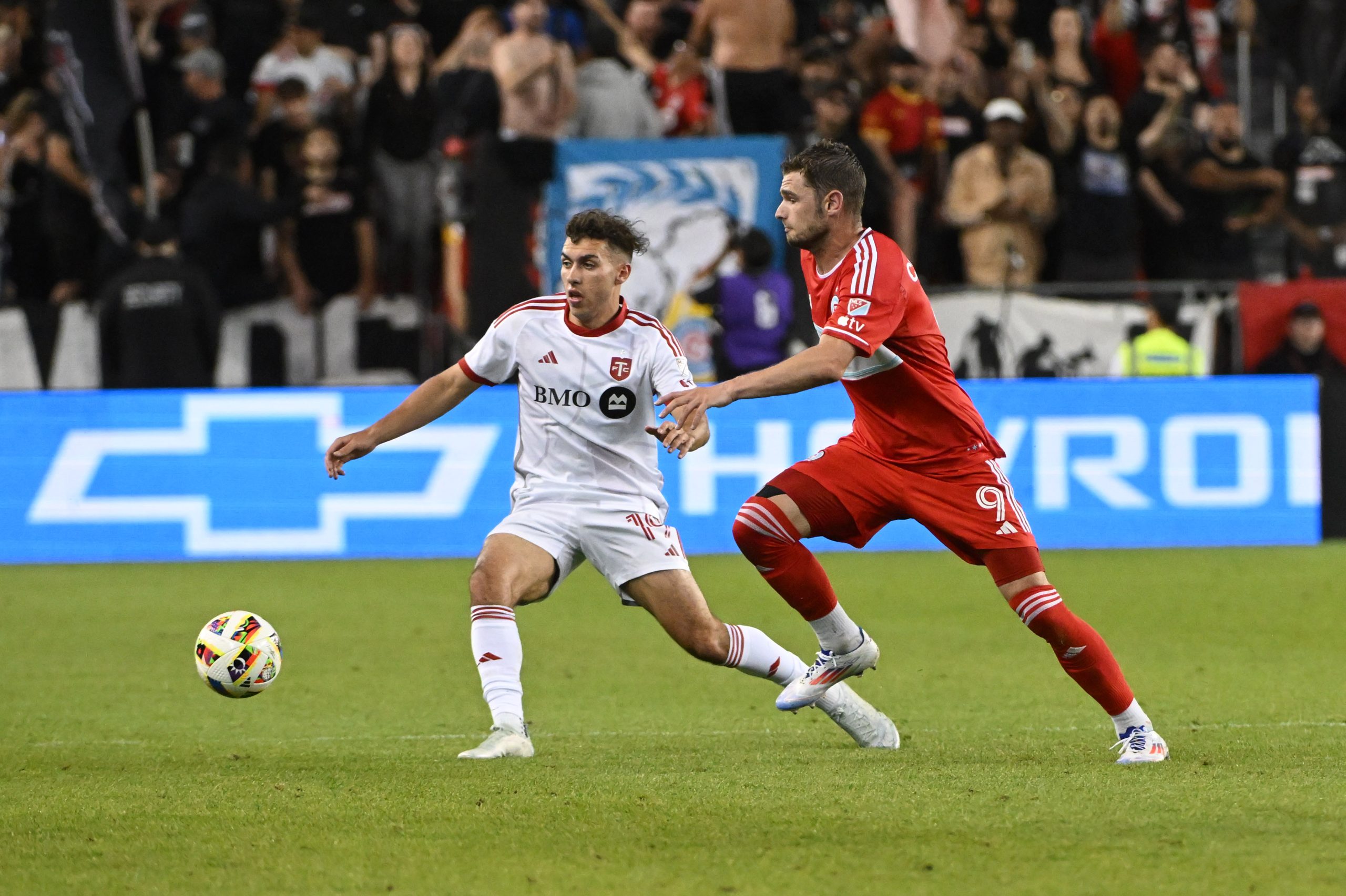 Jun 15, 2024; Toronto, Ontario, CAN; Toronto FC defender Kobe Franklin (19) and Chicago Fire FC forward Hugo Cuypers (9) battle for the ball in the second half at BMO Field. Mandatory Credit: 