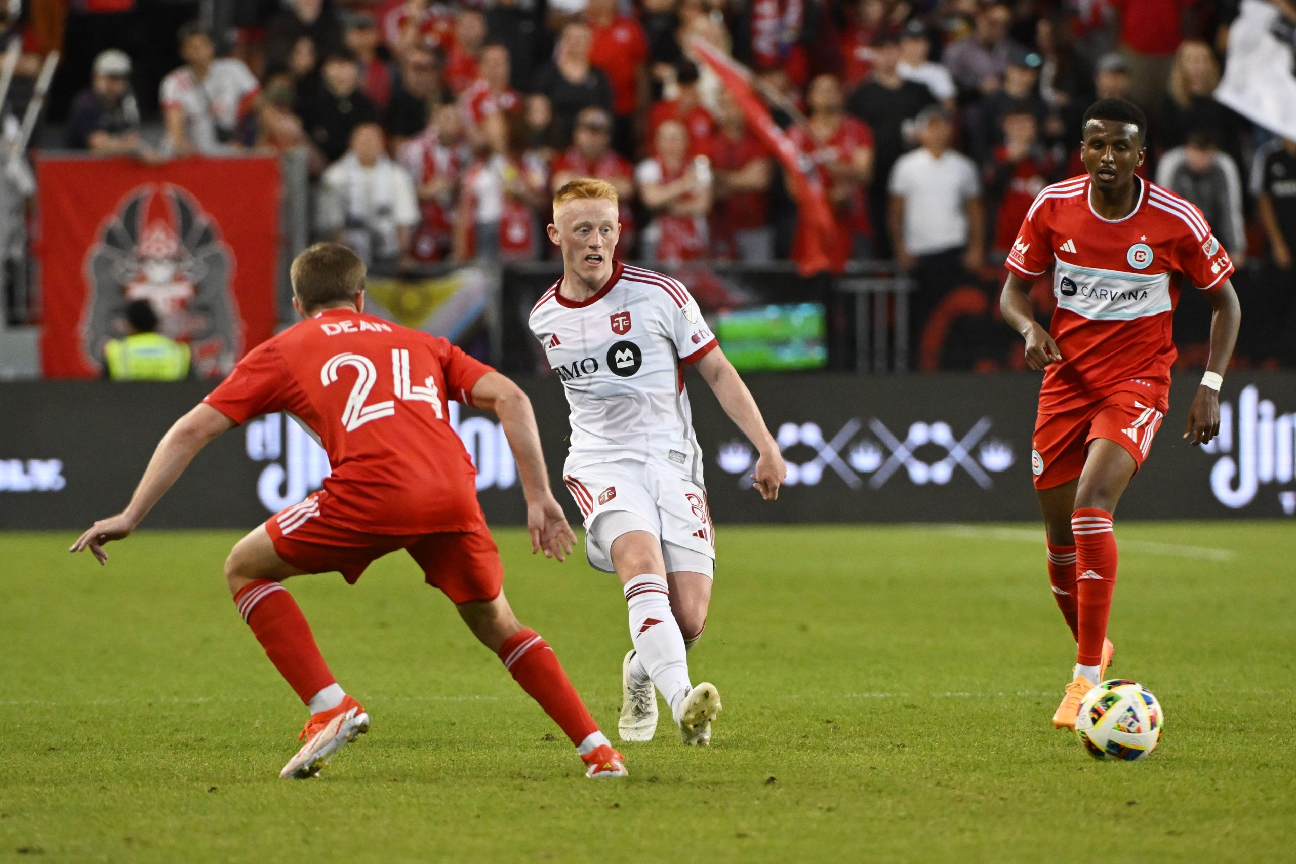 Jun 15, 2024; Toronto, Ontario, CAN; Toronto FC midfielder Matty Longstaff (8) controls the ball against Chicago Fire FC midfielder Jonathan Dean (24) and midfielder Maren Haile-Selassie (7) in the second half at BMO Field. 