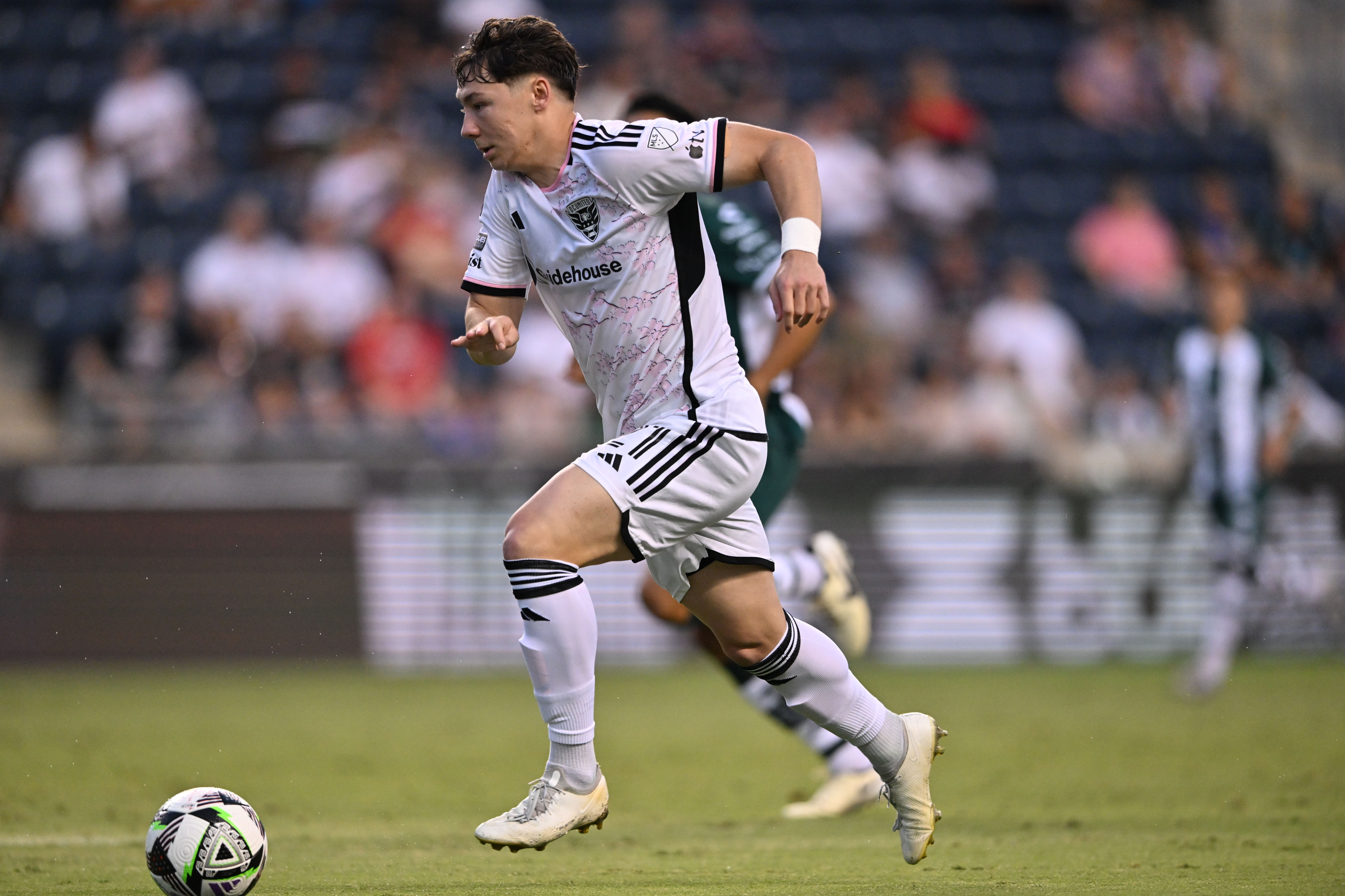 Jul 31, 2024; Chester, Pennsylvania, USA; D.C. United midfielder Ted Ku-DiPietro (21) controls the ball against Santos Laguna in the first half at Subaru Park.