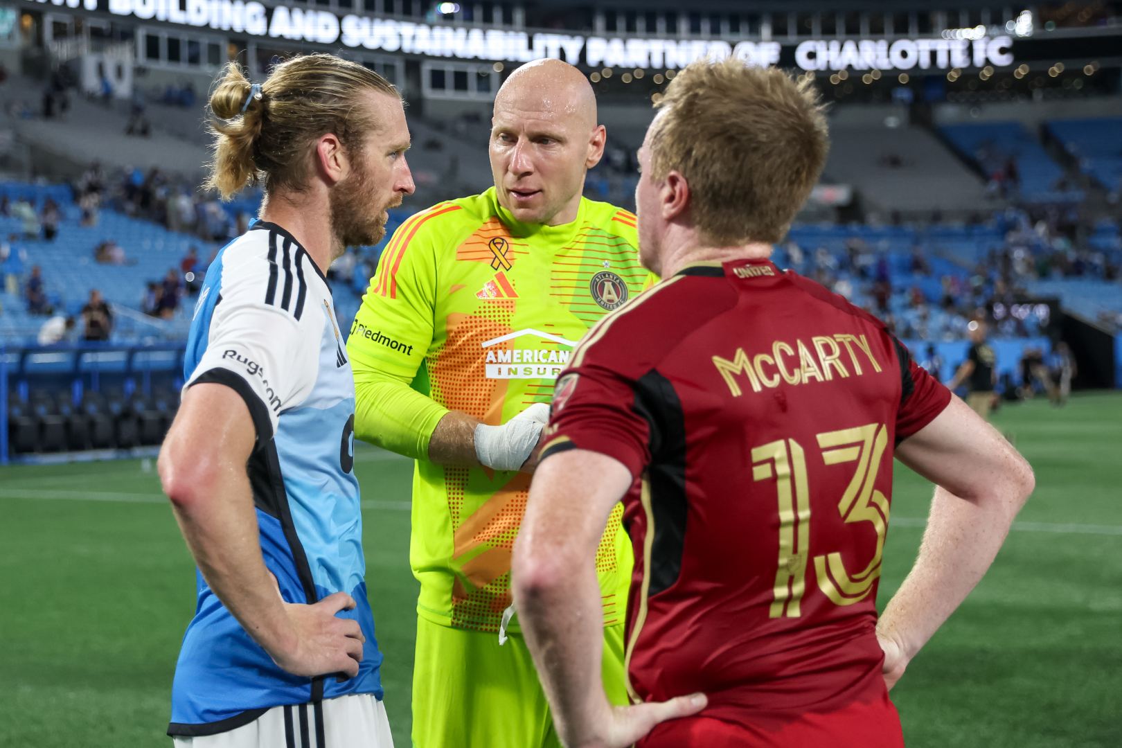 Aug 31, 2024; Charlotte, North Carolina, USA; Charlotte FC defender Tim Ream (3) talks with Atlanta United midfielder Dax McCarty (13) and Atlanta United goalkeeper Brad Guzan (1) after the second half at Bank of America Stadium. Mandatory Credit: Cory Knowlton-USA TODAY Sports