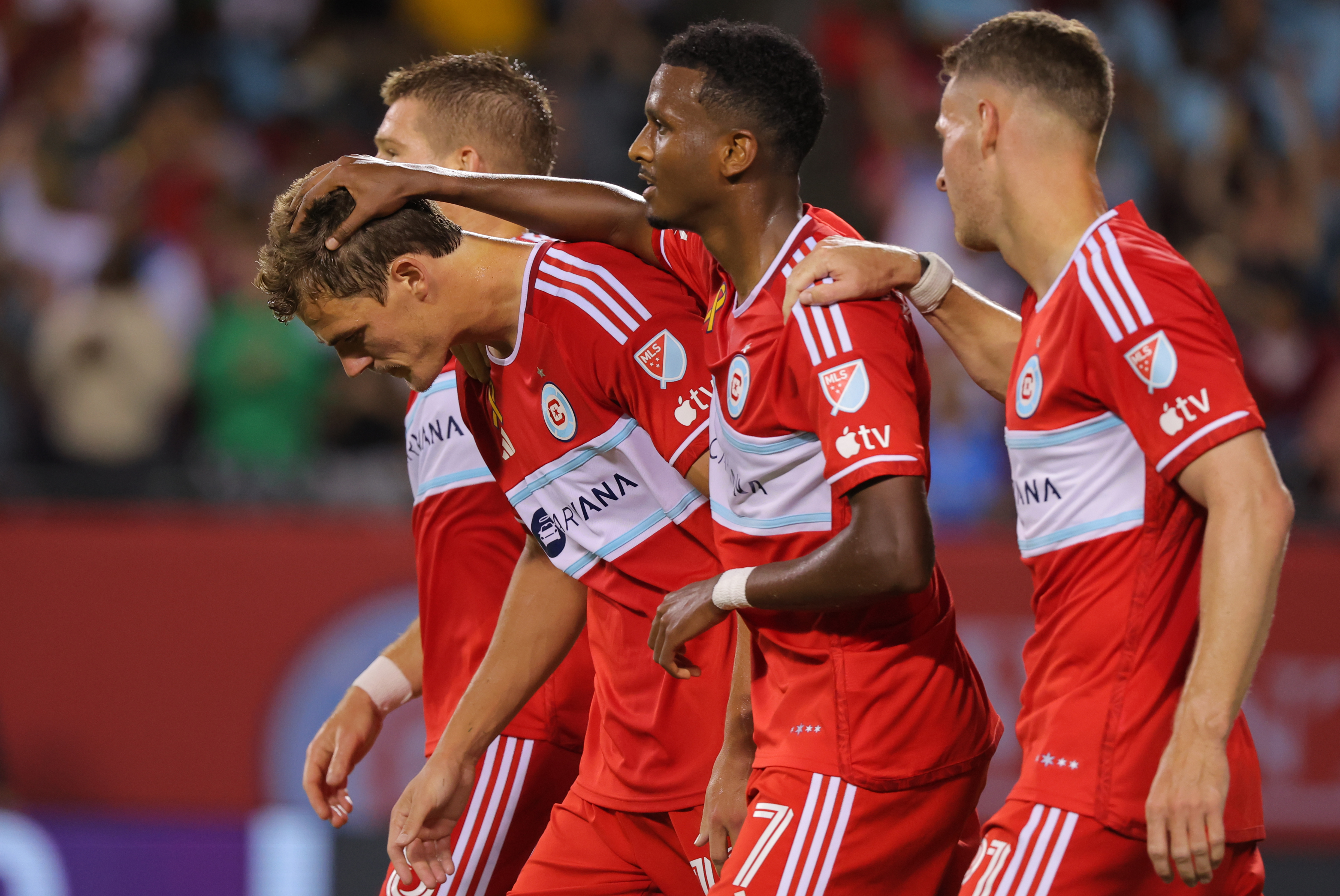 Sep 14, 2024; Chicago, Illinois, USA; Chicago Fire FC forward Tom Barlow (12) celebrates with Chicago Fire FC midfielder Maren Haile-Selassie (7) after scoring a goal during the first half of a match against New York Red Bulls at Soldier Field. 