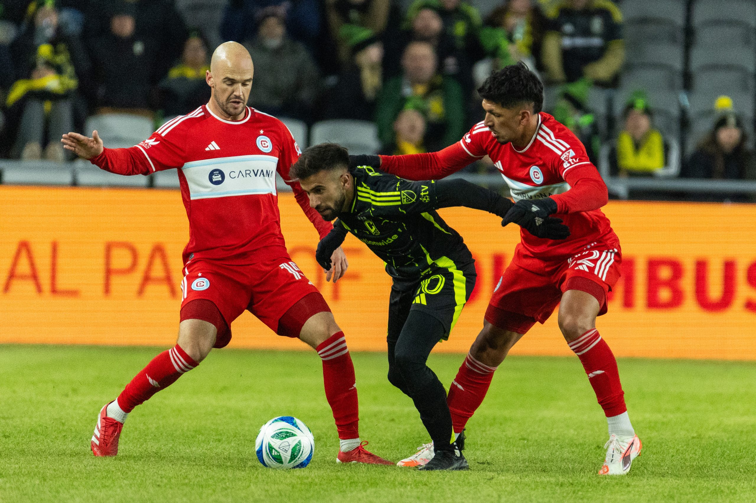 Feb 22, 2025; Columbus, Ohio, USA; Columbus Crew forward Diego Rossi (10) dribbles the ball while Chicago Fire FC defender Mauricio Pineda (22) defends in the second half at Lower.com Field. Mandatory Credit: Trevor Ruszkowski-Imagn Images