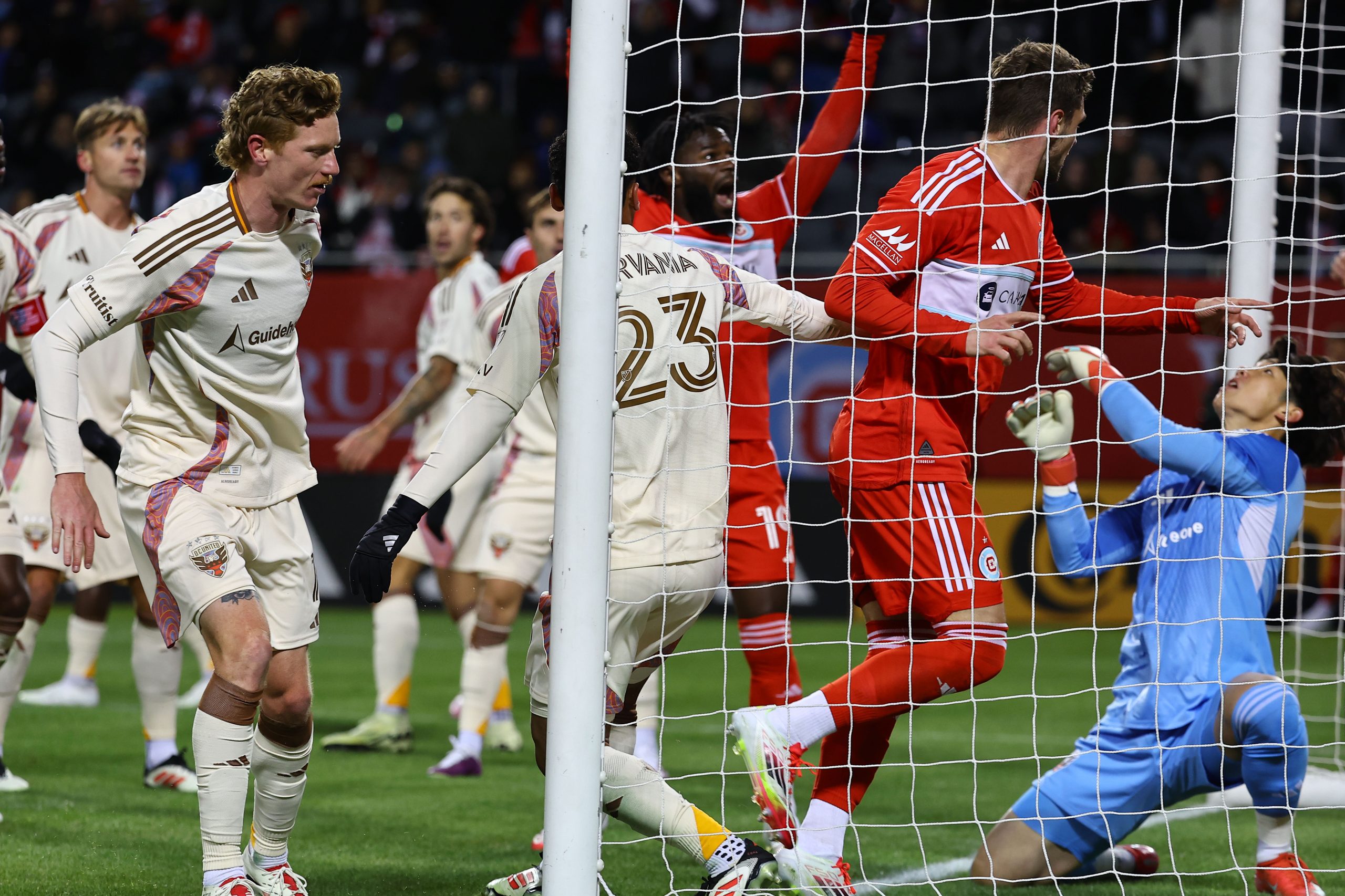 Mar 1, 2025; Chicago, Illinois, USA; Chicago Fire FC forward Hugo Cuypers (9) scores a goal against D.C. United goalkeeper Kim Joon-Hong (1) during the first half at Soldier Field. Mandatory Credit: 
