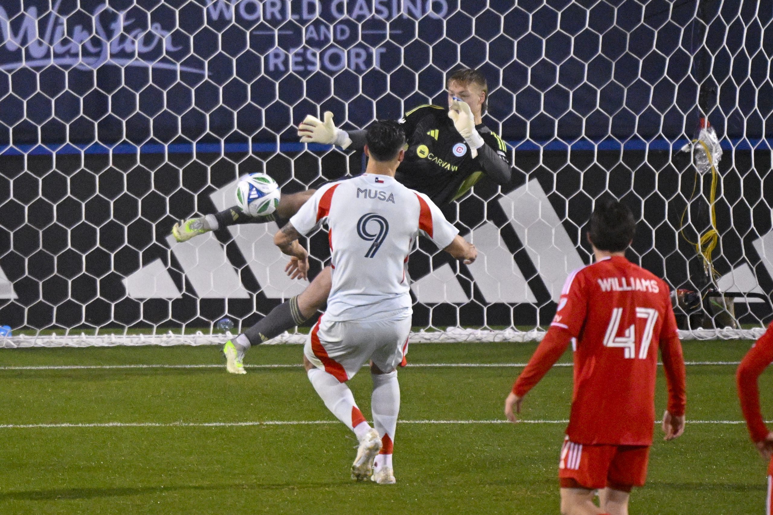 Mar 8, 2025; Frisco, Texas, USA; Chicago Fire goalkeeper Chris Brady (1) makes a save on a penalty kick attempt by FC Dallas forward Petar Musa (9) during the second half at Toyota Stadium. Mandatory Credit: 