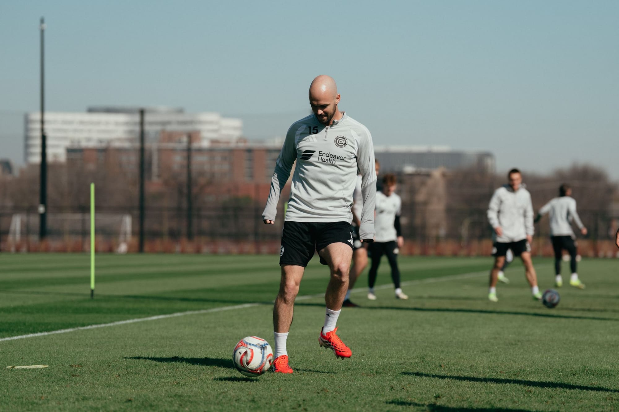 Andrew Gutman and other players on a soccer pitch in training.