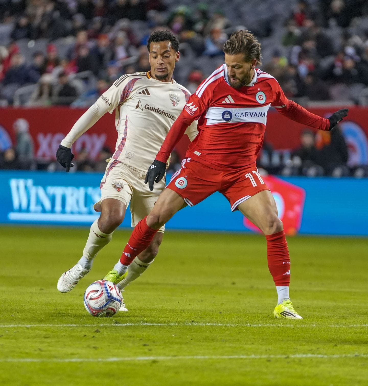 The Chicago Fire's Philip Zinckernagel and a D.C. United player contest the ball.