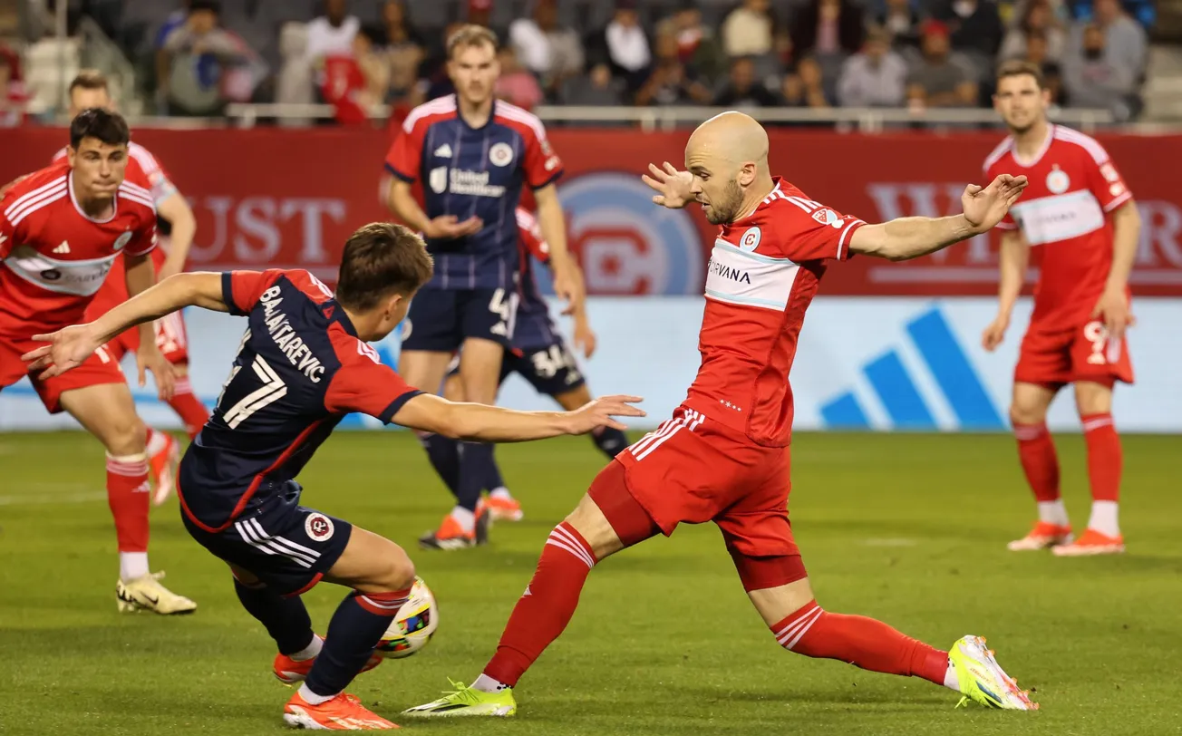 May 4, 2024; Chicago, Illinois, USA; Chicago Fire FC defender Andrew Gutman (15) shoots the ball against the New England Revo