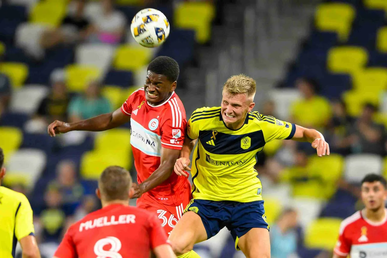 Sep 18, 2024; Nashville, Tennessee, USA; Chicago Fire defender Justin Reynolds (36) heads the ball over Nashville SC forward