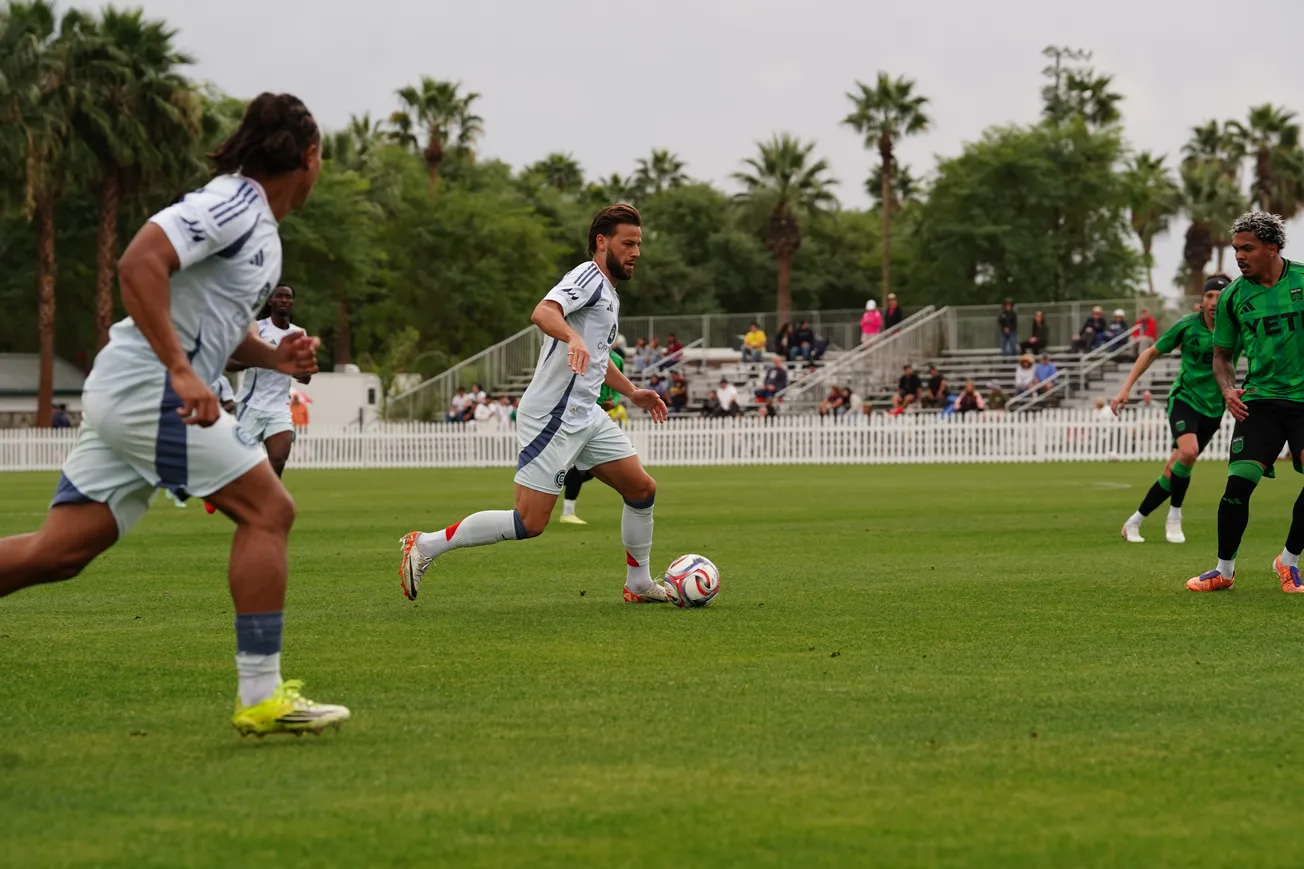 Phillip Zinckernagel carries the ball forward with Leonardo Barroso in support as the Fire play Austin on February 11, 2026