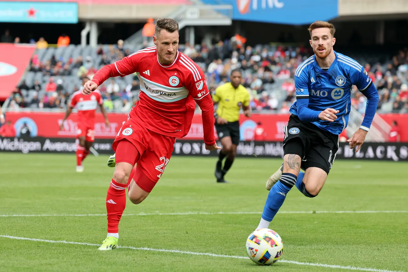 During the a game at Soldier Field in 2024, the Fire's Fabian Herbers and CF Montréal's Joel Waterman challenge for the ball